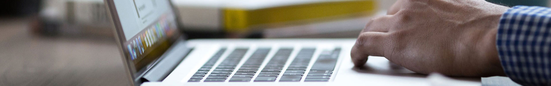 Man creating web development code on a laptop